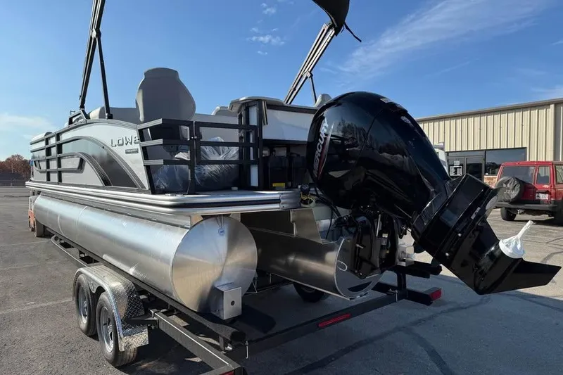 Slide: The Image of 2026 Lowe SF 232 Sport Fish pontoon boat on trailer, featuring powerful outboard motor. - 5