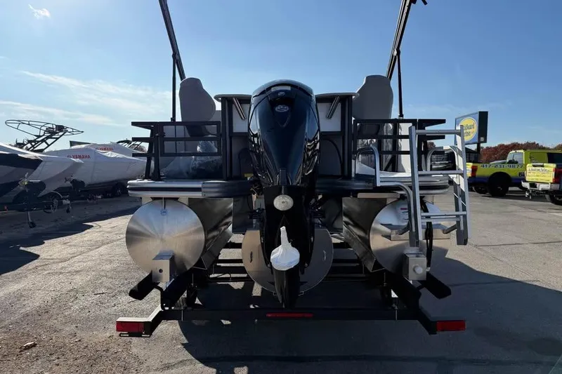 Slide: The Image of 2026 Lowe SF 232 Sport Fish pontoon boat with outboard motor, parked outdoors. - 6