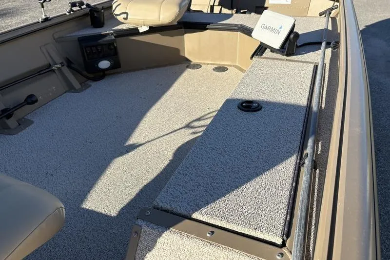 Slide: The Image of 2025 SeaArk DXS 1548 DKLD boat interior with Garmin equipment and seating. - 11