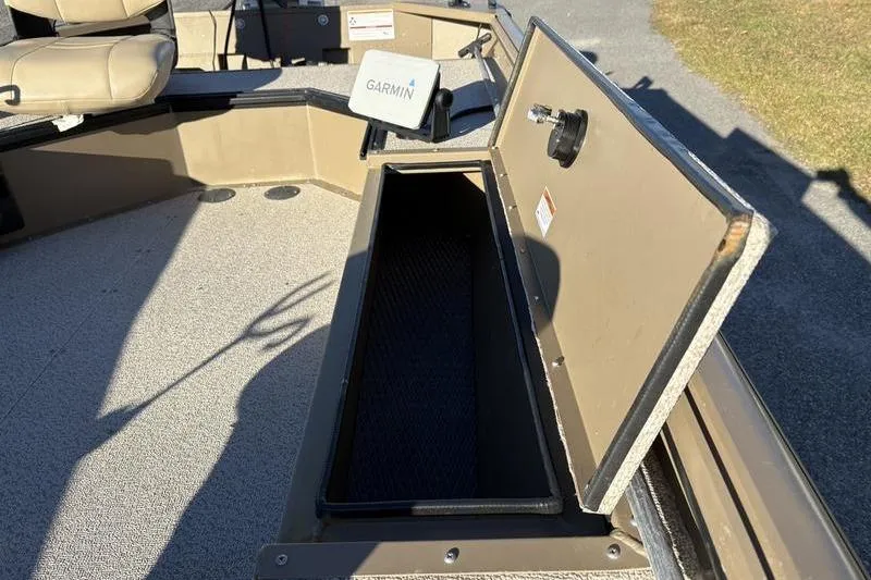 Slide: The Image of 2025 SeaArk DXS 1548 DKLD boat with open storage compartment and Garmin device. - 12