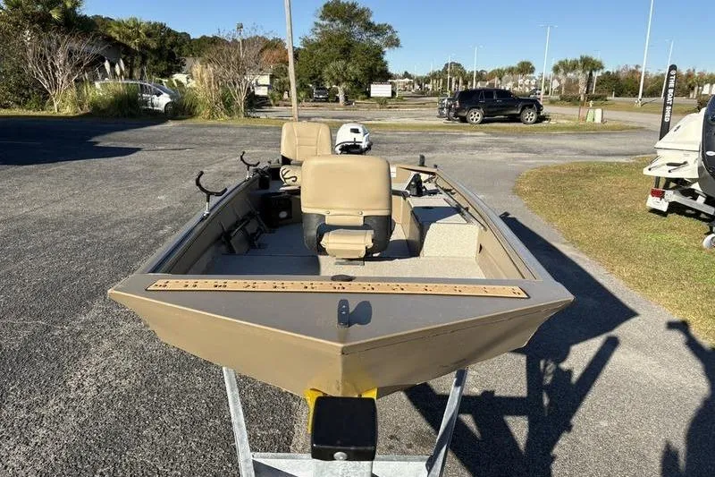 Slide: The Image of 2025 SeaArk DXS 1548 DKLD boat on trailer in outdoor setting. - 6