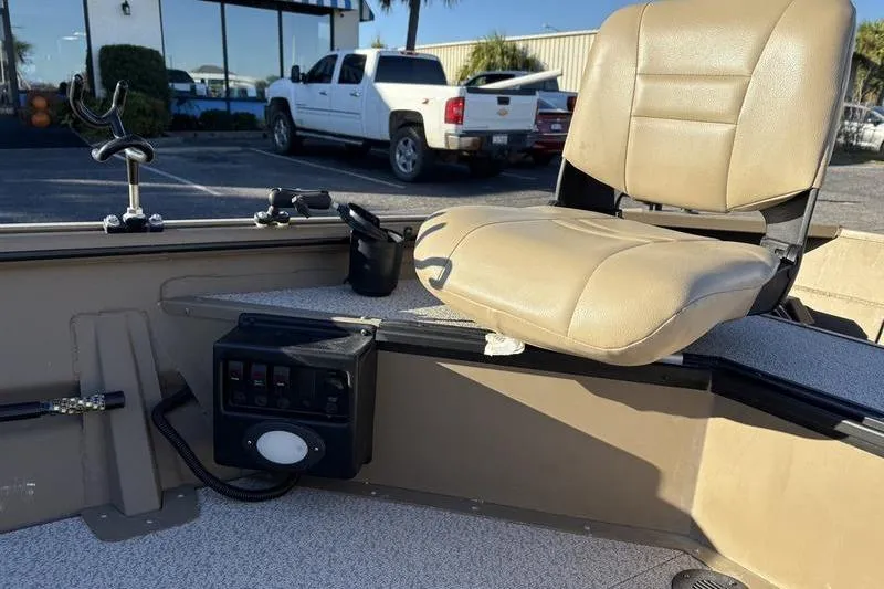 Slide: The Image of 2025 SeaArk DXS 1548 DKLD boat interior with beige seat and control panel. - 9