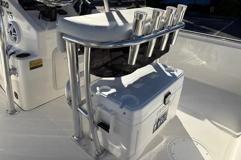 Slide: The Image of 2026 Bulls Bay 2200 XS boat interior with rod holders and cooler. - 12