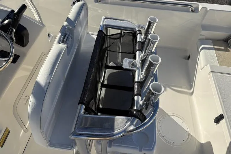 Slide: The Image of 2026 Bulls Bay 2200 XS boat interior with rod holders and seating. - 13