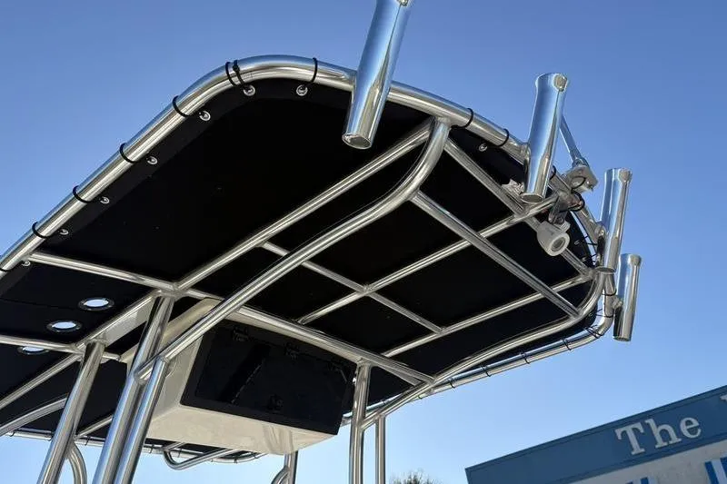Slide: The Image of T-top of 2026 Bulls Bay 2200 XS boat with rod holders against blue sky. - 14