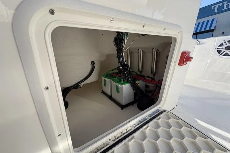 Slide: The Image of Battery compartment of 2026 Bulls Bay 2200 XS boat, showcasing wiring and storage. - 21