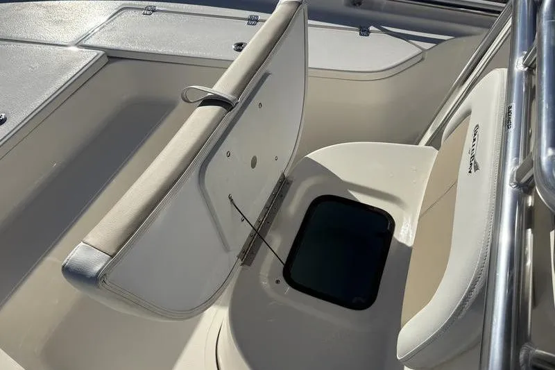 Slide: The Image of 2026 Bulls Bay 2200 XS boat interior with open storage compartment and cushioned seating. - 26