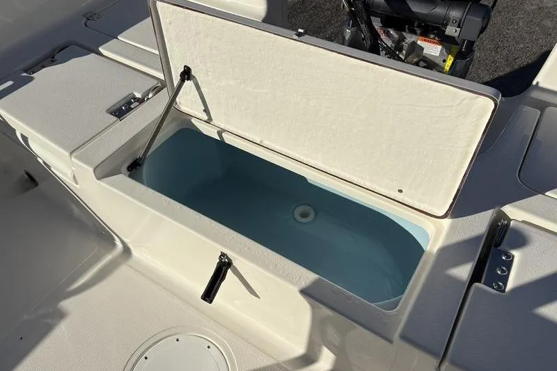 Slide: The Image of Open storage compartment on 2026 Bulls Bay 2200 XS boat, showcasing interior design. - 9