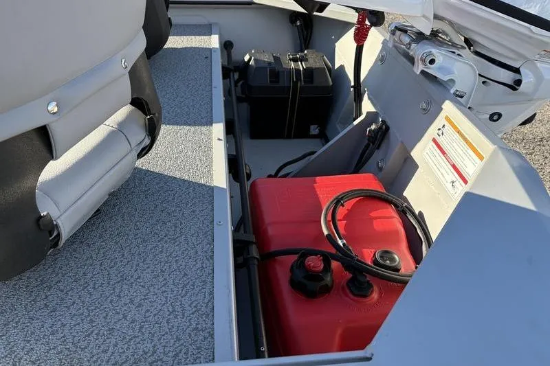 Slide: The Image of 2025 SeaArk DXS 1548 DKLD boat interior with red fuel tank and battery compartment. - 10