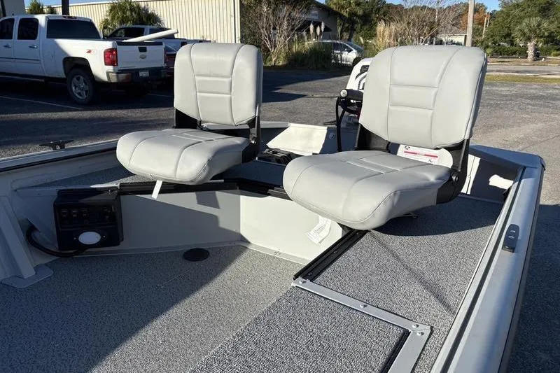 Slide: The Image of 2025 SeaArk DXS 1548 DKLD boat interior with two gray seats. - 11