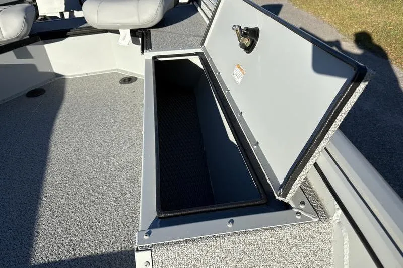 Slide: The Image of Open storage compartment on 2025 SeaArk DXS 1548 DKLD boat deck. - 13
