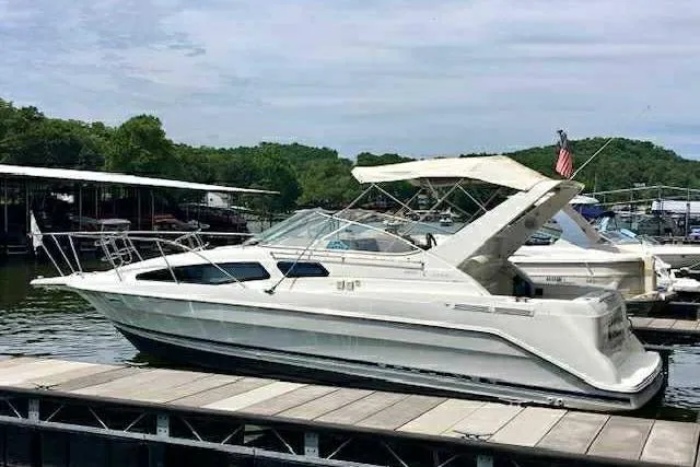The Image of 1999 Bayliner 2855 Ciera boat docked at a marina with scenic background. - 0