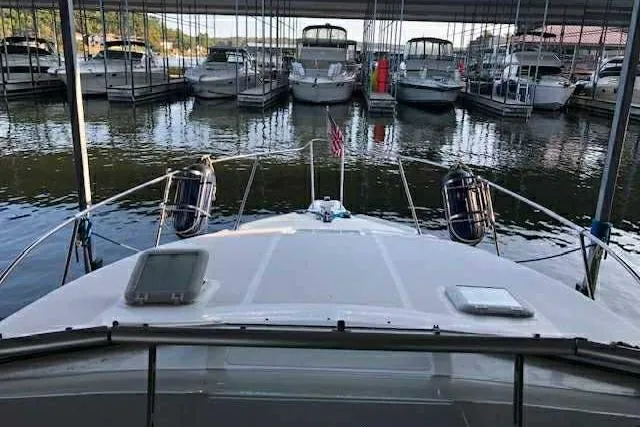 Slide: The Image of 1999 Bayliner 2855 Ciera docked in a marina with multiple boats. - 12