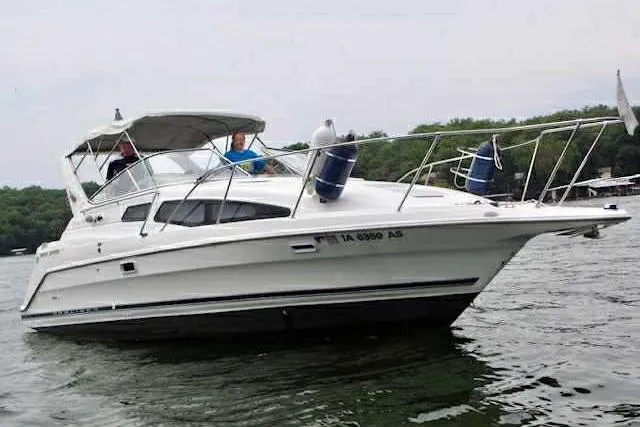 Slide: The Image of 1999 Bayliner 2855 Ciera boat cruising on a lake with passengers onboard. - 16