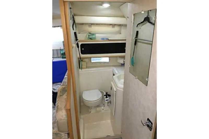 Slide: The Image of 1999 Bayliner 2855 Ciera boat bathroom interior with toilet, sink, and mirror. - 5