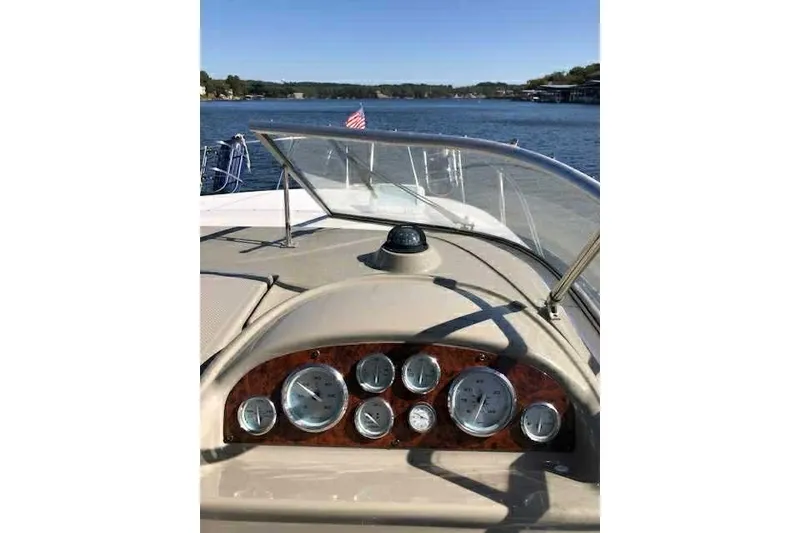 Slide: The Image of 1999 Bayliner 2855 Ciera dashboard with gauges, on a scenic lake. - 6