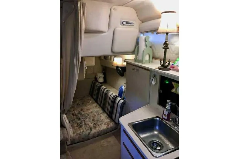 Slide: The Image of Interior of 1999 Bayliner 2855 Ciera boat with cozy cabin and kitchenette. - 7