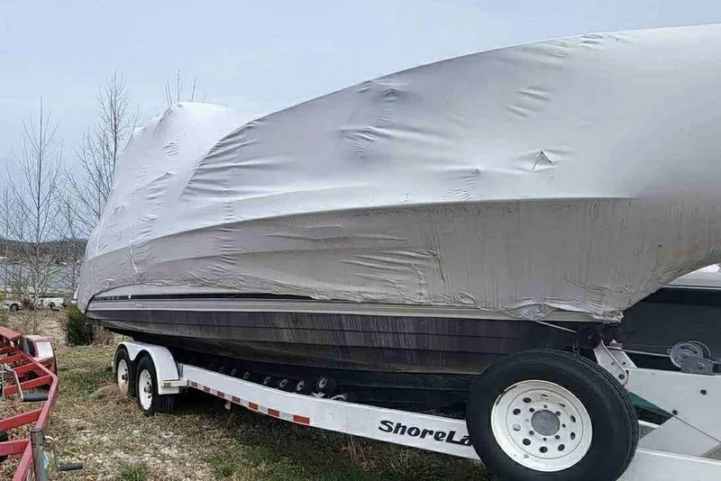 Slide: The Image of 1999 Bayliner 2855 Ciera boat covered on trailer, parked outdoors. - 9