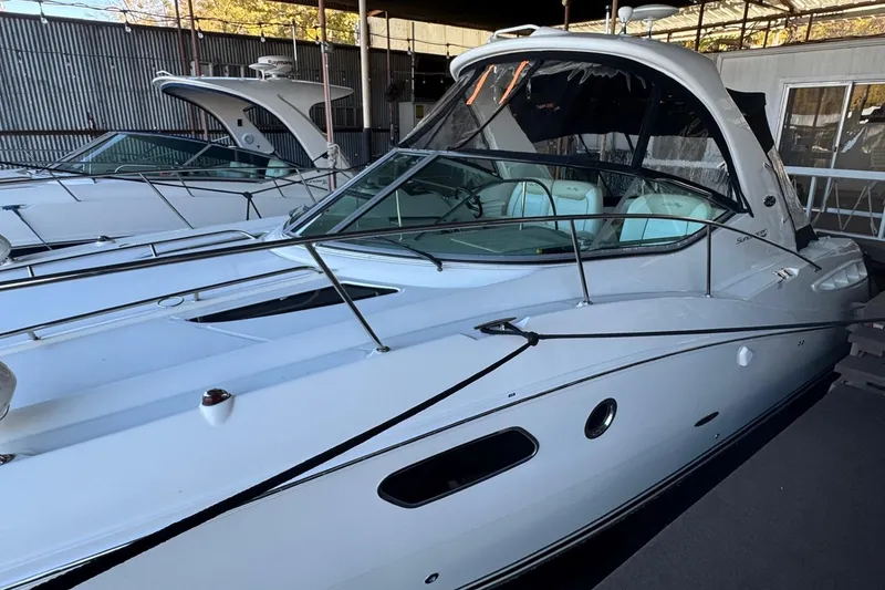 Slide: The Image of 2010 Sea Ray 350 Sundancer yacht docked in a marina, side view. - 1