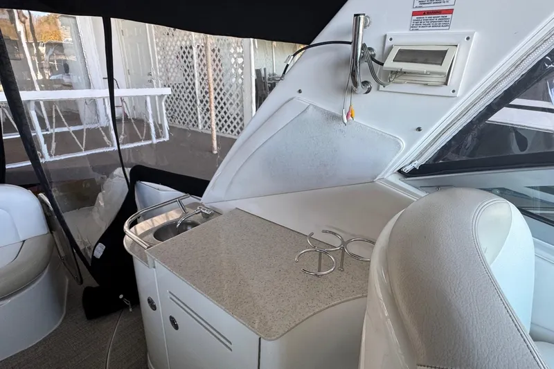 Slide: The Image of Interior of 2010 Sea Ray 350 Sundancer with kitchenette and seating area. - 13