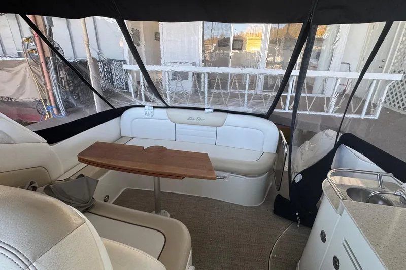 Slide: The Image of Interior of 2010 Sea Ray 350 Sundancer with seating, table, and kitchenette. - 14