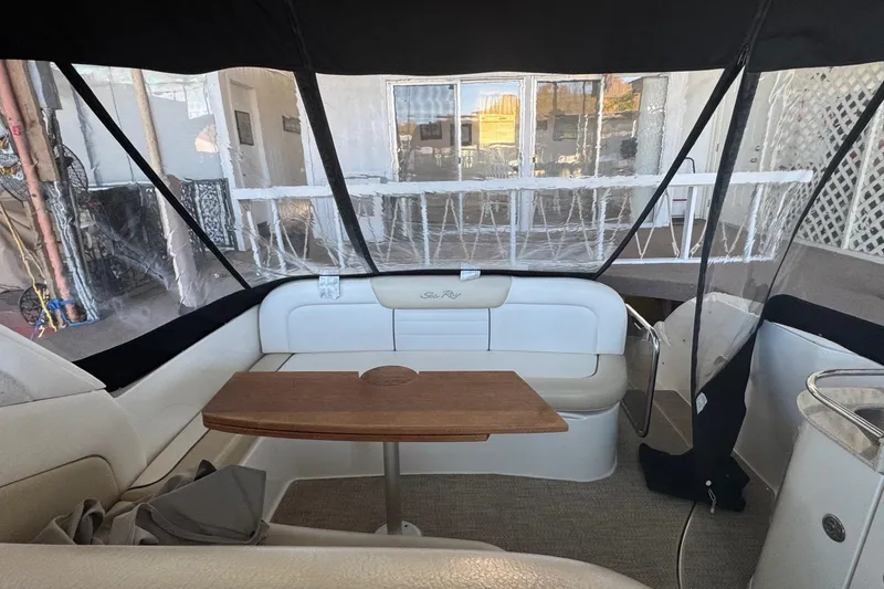 Slide: The Image of Interior of 2010 Sea Ray 350 Sundancer with seating and wooden table. - 15