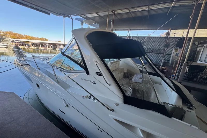 Slide: The Image of 2010 Sea Ray 350 Sundancer docked under a covered marina. - 2