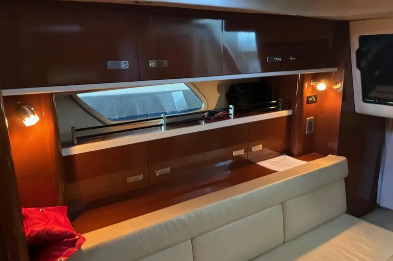 Slide: The Image of Interior of 2010 Sea Ray 350 Sundancer yacht with wood cabinets and beige seating. - 20