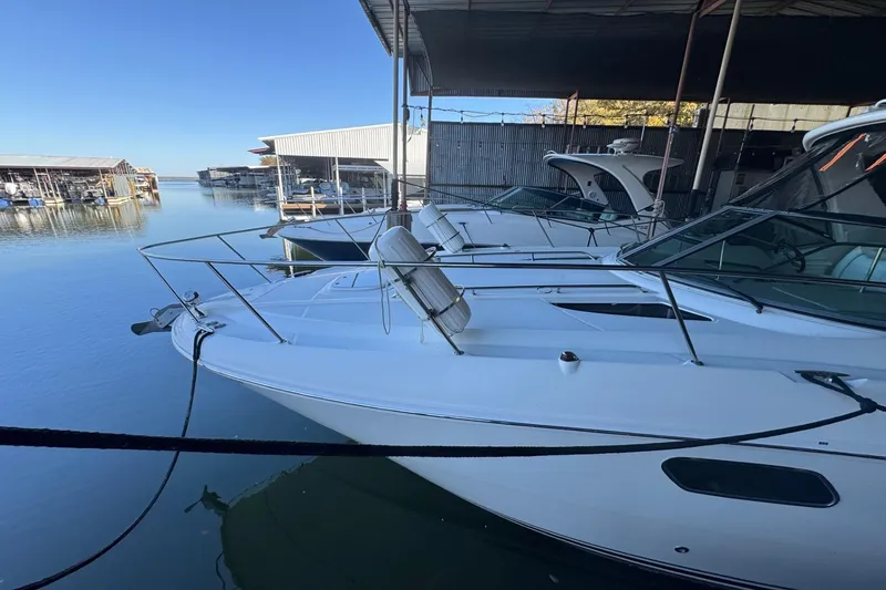 Slide: The Image of 2010 Sea Ray 350 Sundancer docked at a marina under a clear blue sky. - 8