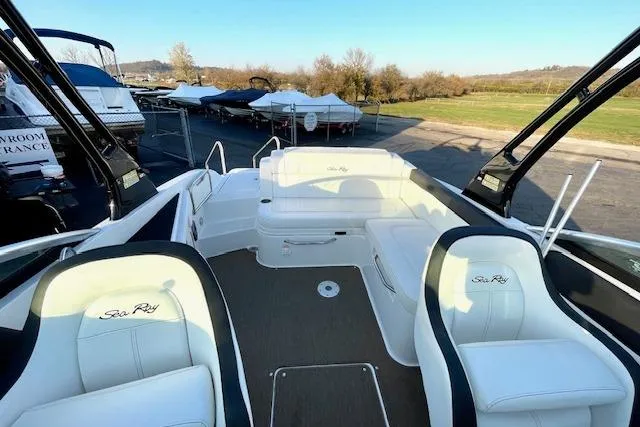 Slide: The Image of 2014 Sea Ray 260 Sundeck boat interior with white seating and open deck. - 10