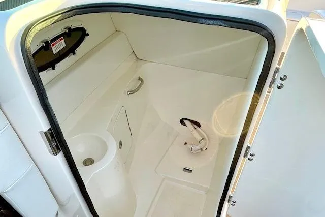 Slide: The Image of 2014 Sea Ray 260 Sundeck interior cabin with sink and storage. - 12