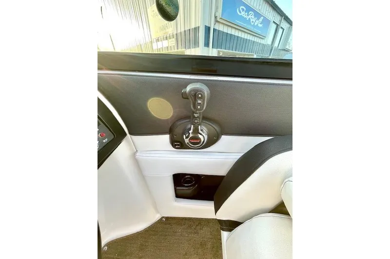 Slide: The Image of 2014 Sea Ray 260 Sundeck interior with control panel and seating. - 17