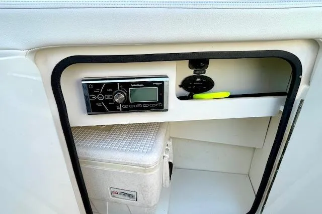 Slide: The Image of 2014 Sea Ray 260 Sundeck storage compartment with stereo system and cooler. - 19