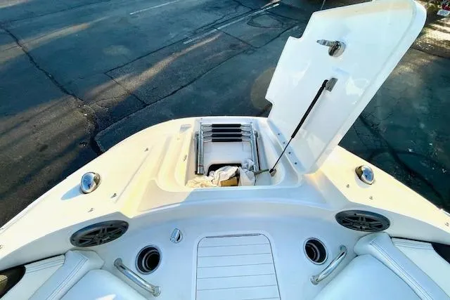 Slide: The Image of 2014 Sea Ray 260 Sundeck boat with open storage compartment on deck. - 23