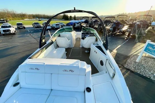 Slide: The Image of 2014 Sea Ray 260 Sundeck boat with white seating, parked outdoors in a marina. - 9