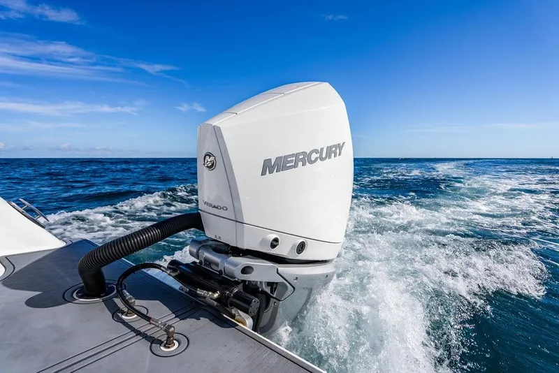 Slide: The Image of Reef Runner 230 boat with Mercury Verado engine cruising on open sea, 2026 model. - 29