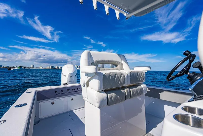 Slide: The Image of 2026 Reef Runner 230 boat interior with luxurious seating on open water. - 33