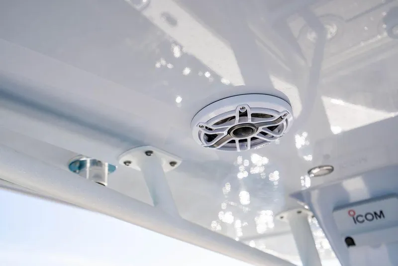 Slide: The Image of Speaker system on 2026 Reef Runner 230 boat, featuring sleek design and Icom equipment. - 41