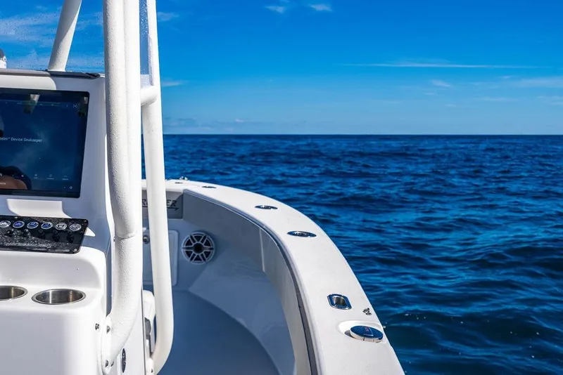 Slide: The Image of 2026 Reef Runner 230 boat on open ocean under clear blue sky. - 43