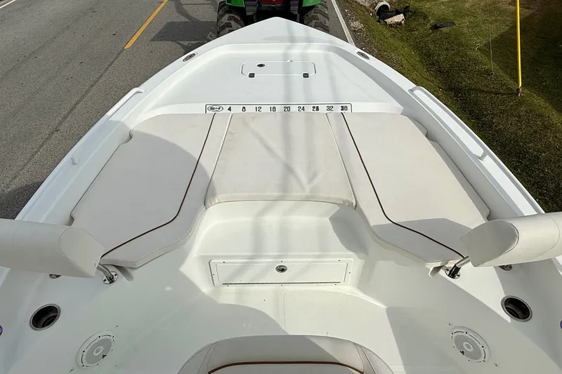 Slide: The Image of 2021 Sea Hunt BX 25 FS boat deck with cushioned seating and measurement markings. - 15