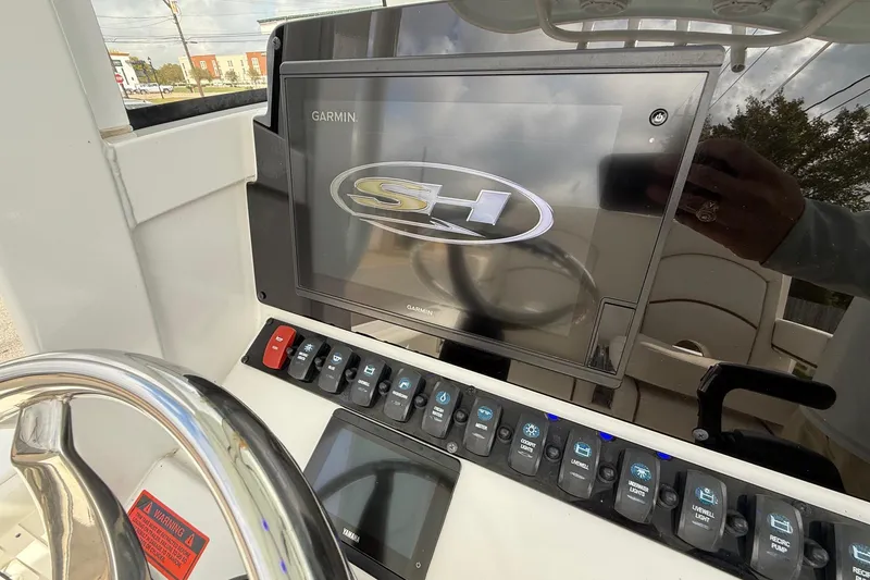 Slide: The Image of 2021 Sea Hunt BX 25 FS boat dashboard with Garmin display and control panel. - 18