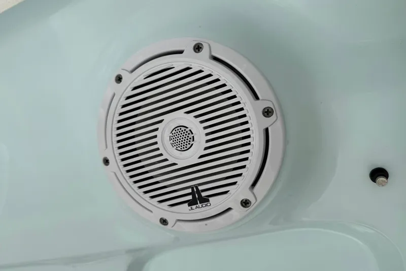 Slide: The Image of White JL Audio speaker on 2021 Sea Hunt BX 25 FS boat interior. - 21