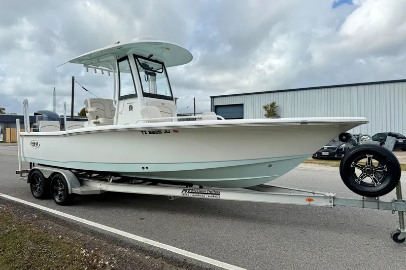 Slide: The Image of 2021 Sea Hunt BX 25 FS boat on trailer, parked outdoors under cloudy sky. - 5