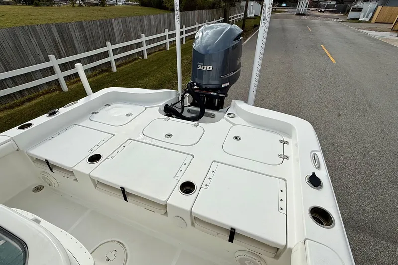 Slide: The Image of 2021 Sea Hunt BX 25 FS boat with Yamaha 300 outboard motor, docked on a paved road. - 8
