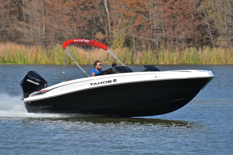 The Image of 2024 Tahoe T21 boat cruising on a lake with a Mercury engine. - 1