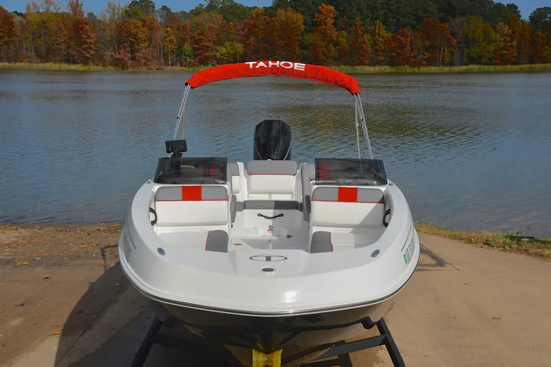 Slide: The Image of 2024 Tahoe T21 boat at lakeside with autumn foliage backdrop. - 17