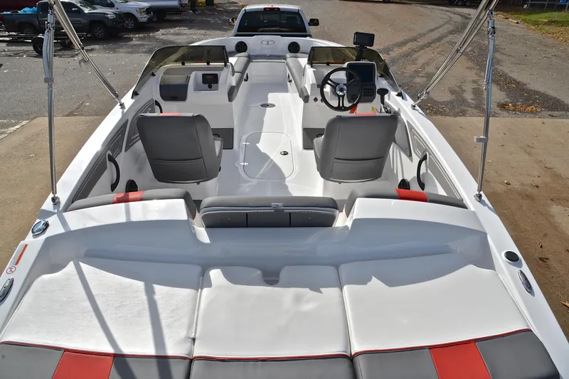 Slide: The Image of 2024 Tahoe T21 boat interior with seating, steering wheel, and dashboard controls. - 18