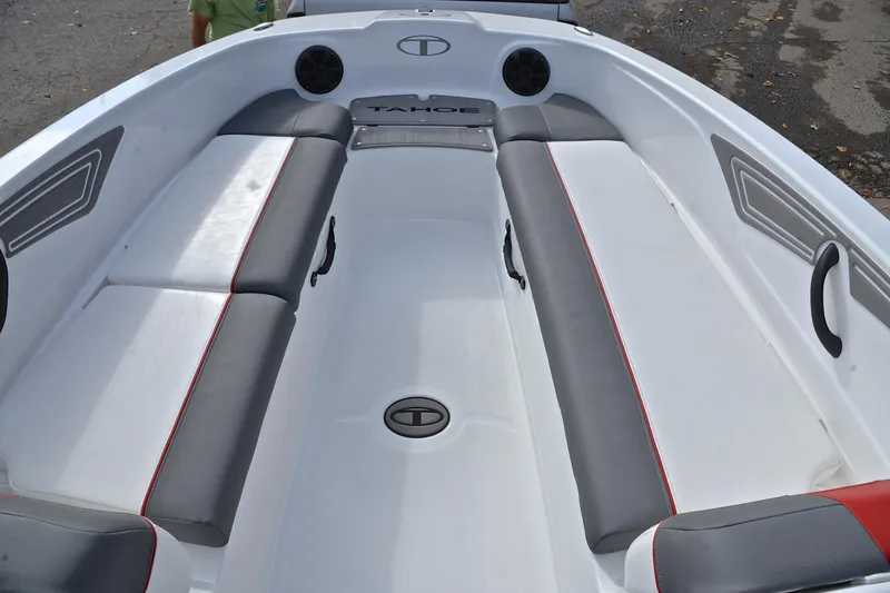 Slide: The Image of 2024 Tahoe T21 boat interior with gray and red seating, sleek design. - 21