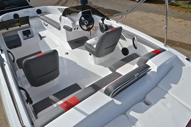 Slide: The Image of 2024 Tahoe T21 boat interior with modern seating and steering console. - 23