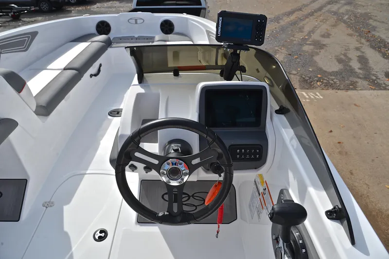 Slide: The Image of 2024 Tahoe T21 boat cockpit with steering wheel, control panel, and navigation system. - 25